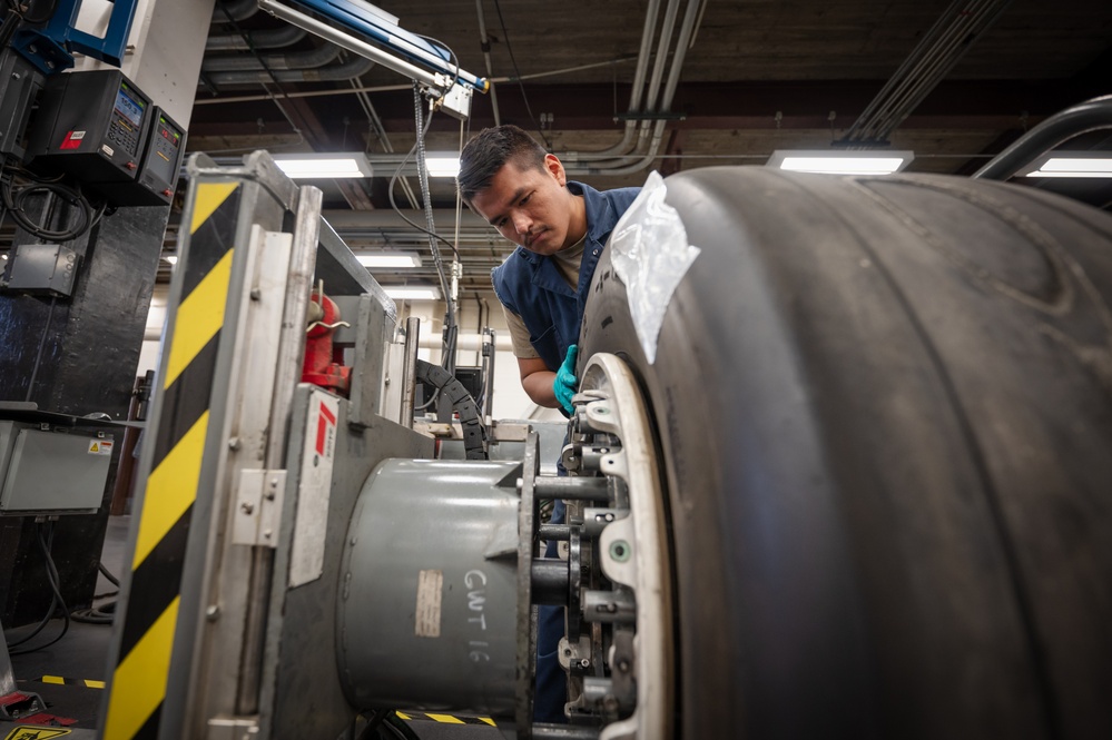 Whiteman wheel and tire technicians service landing gear for B-2 and T-38 aircraft