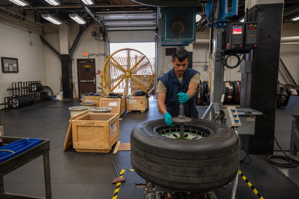 Whiteman wheel and tire technicians service landing gear for B-2 and T-38 aircraft