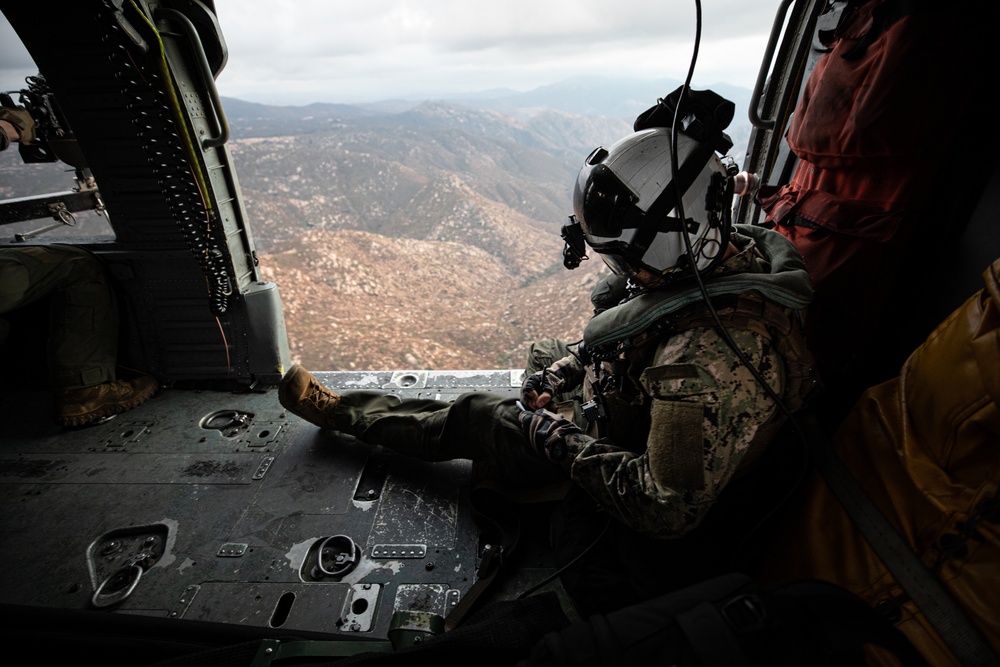 Naval Aircrewman Takes Notes Aboard Search and Rescue Practice Flight