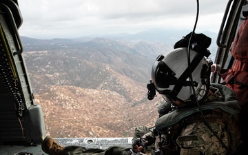 Naval Aircrewman Takes Notes Aboard Search and Rescue Practice Flight