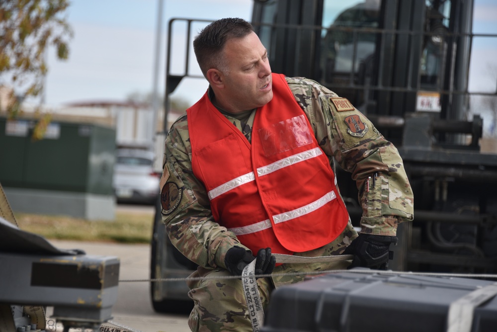 Senior Master Sgt. Aaron Christensen fixes a frustrated pallet