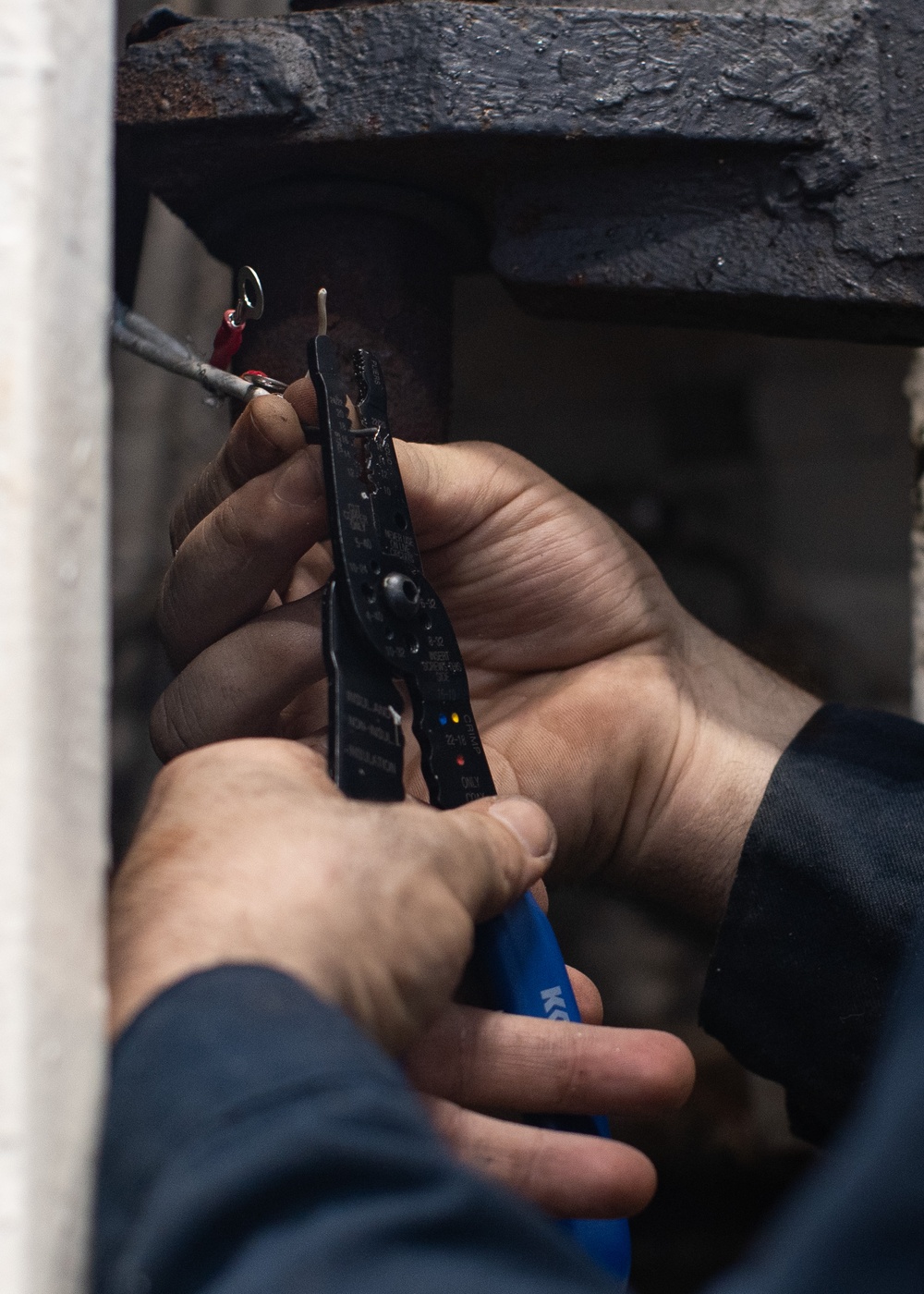 Weapons department Sailor replaces wiring insulation aboard USS George Washington