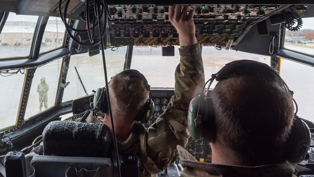 Crew Chiefs with 182nd Aircraft Maintenance Squadron inspect C-130H3 Hercules' APU