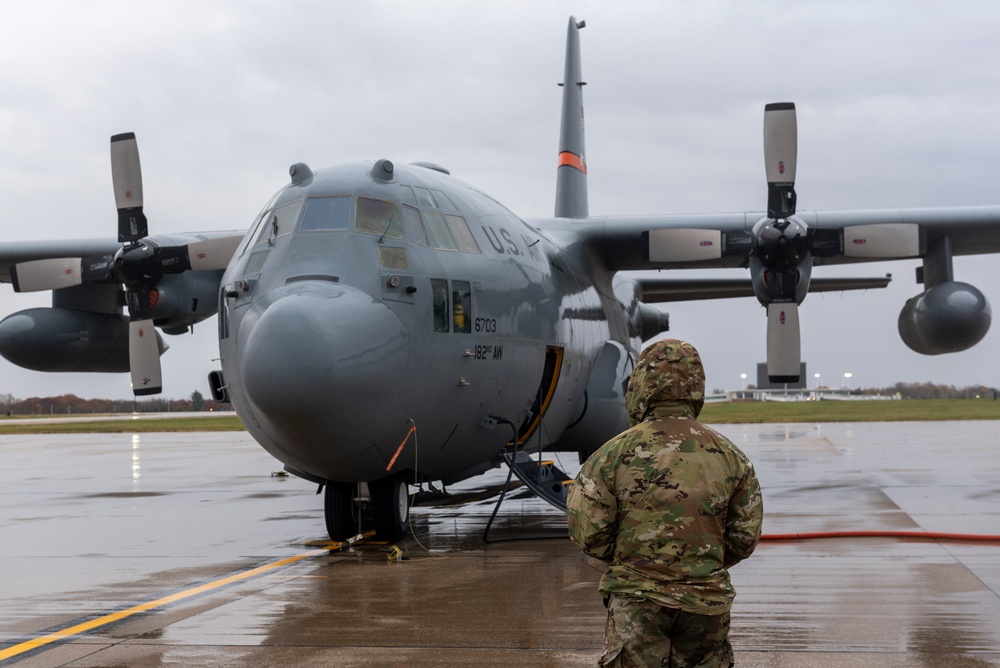 Crew Chiefs with 182nd Aircraft Maintenance Squadron inspect C-130H3 Hercules' APU