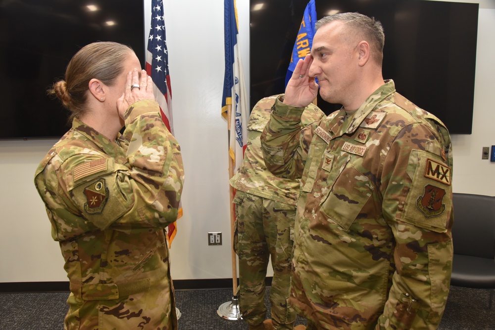 Col. Chad Schoonover salutes 185th ARW Commander Col. Sonya Morrison