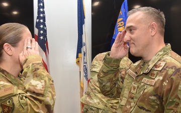 Col. Chad Schoonover salutes 185th ARW Commander Col. Sonya Morrison