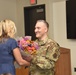 Col. Chad Schoonover hands flowers to his wife