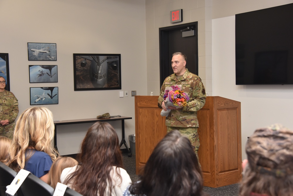 Col. Chad Schoonover prepares to hand flowers to his wife