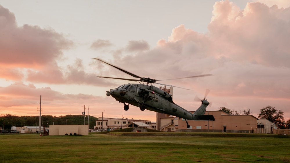 HSC-12 flies during sunset in Guam