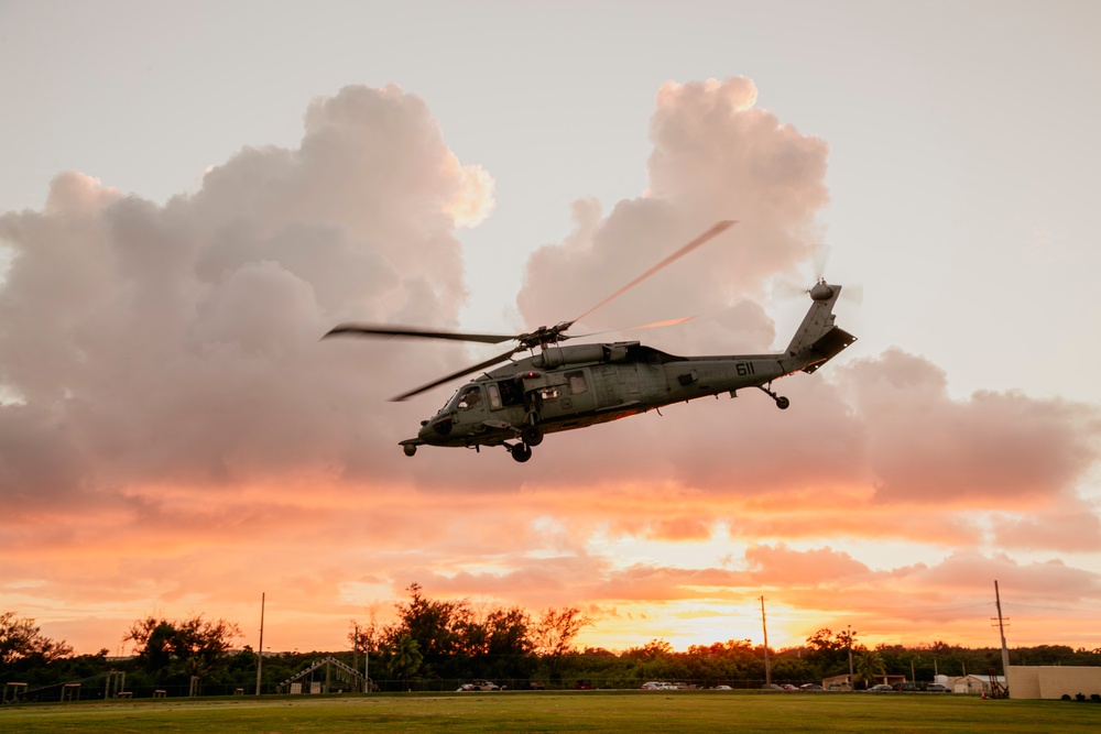 HSC-12 flies during sunset in Guam