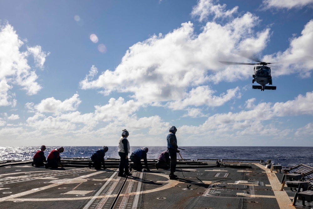 USS Ralph Johnson Conducts A Helicopter in-flight Refueling Exercise.