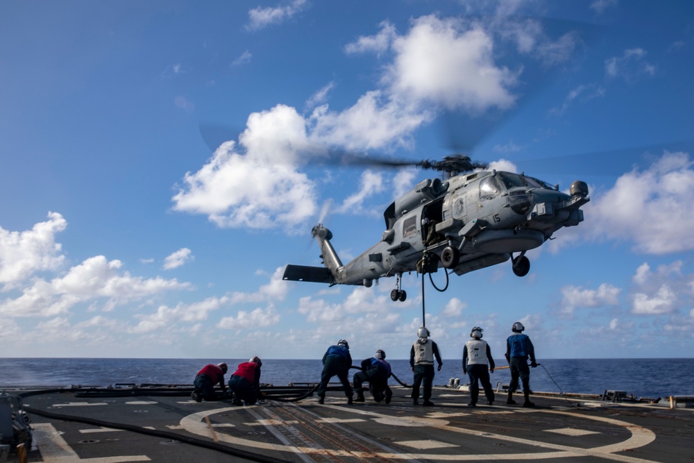 USS Ralph Johnson Conducts A Helicopter in-flight Refueling Exercise.