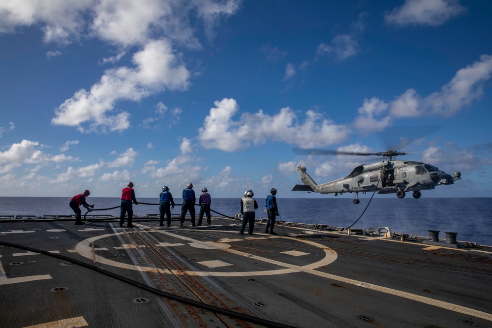 USS Ralph Johnson Conducts A Helicopter in-flight Refueling Exercise.