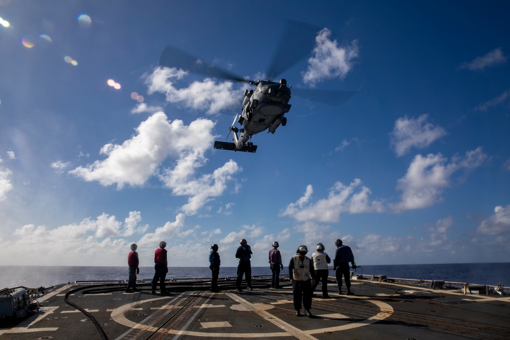 USS Ralph Johnson Conducts A Helicopter in-flight Refueling Exercise.