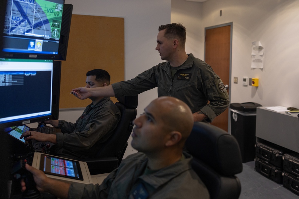 U.S. Marines with VMUT-2 conduct flight simulations and aircraft familiarization