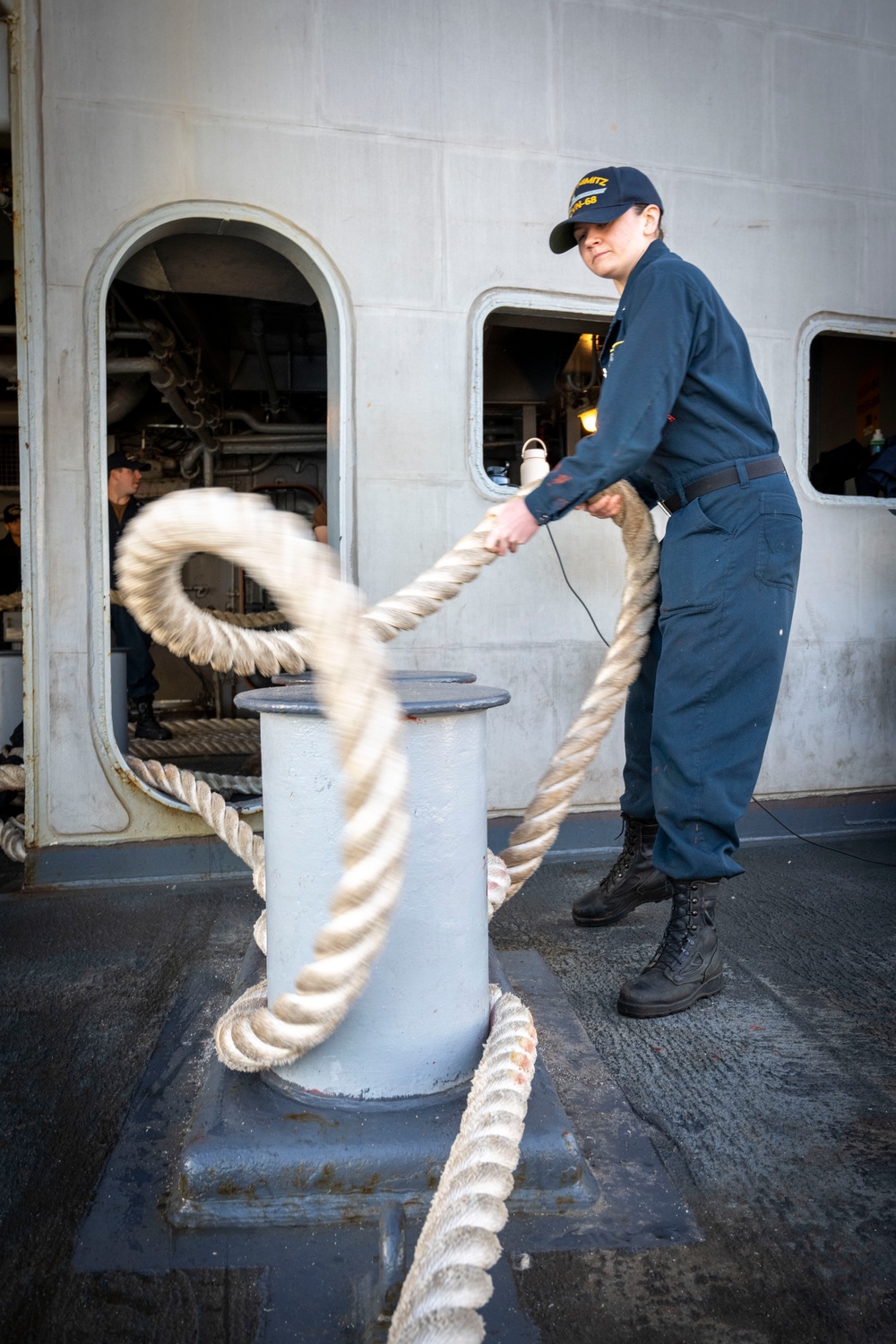 Nimitz Sailor Heaves Around Line On The Fantail