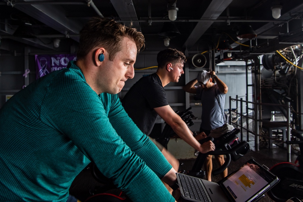 USS Ronald Reagan (CVN 76) Sailors participate in a Cycle-to-End-the-Cycle challenge