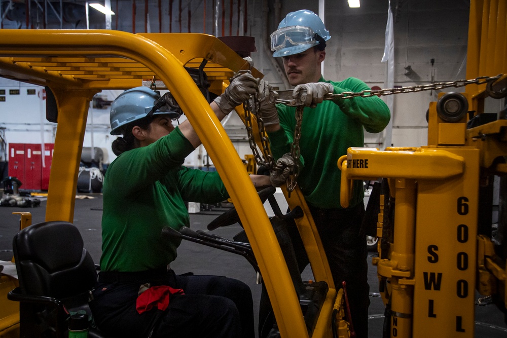 Nimitz Sailors Perform Maintenance on a Forklift