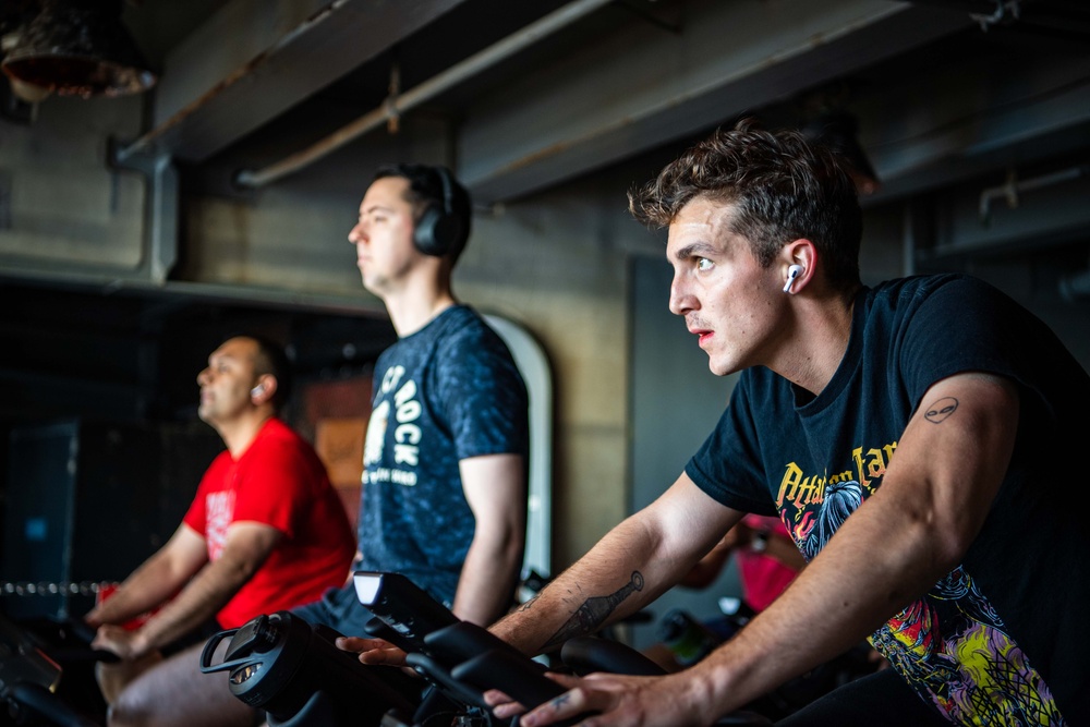 USS Ronald Reagan (CVN 76) Sailors participate in a Cycle-to-End-the-Cycle challenge