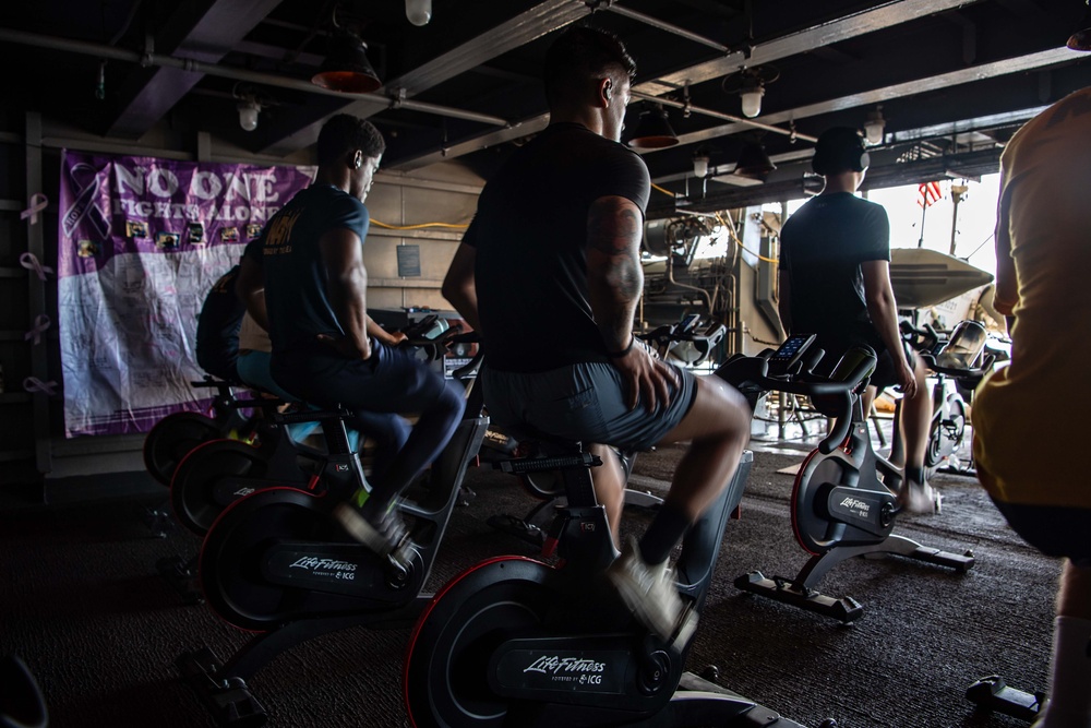 USS Ronald Reagan (CVN 76) Sailors participate in a Cycle-to-End-the-Cycle challenge