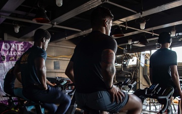 USS Ronald Reagan (CVN 76) Sailors participate in a Cycle-to-End-the-Cycle challenge