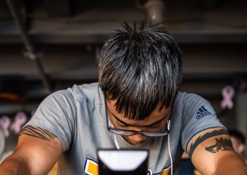 USS Ronald Reagan (CVN 76) Sailors participate in a Cycle-to-End-the-Cycle challenge