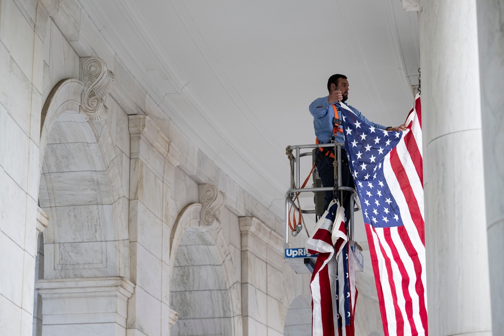 U.S. Flags are Hung in the Memorial Amphitheater in Preparation for the 2024 National Veterans Day Observance