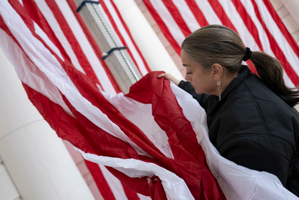 U.S. Flags are Hung in the Memorial Amphitheater in Preparation for the 2024 National Veterans Day Observance