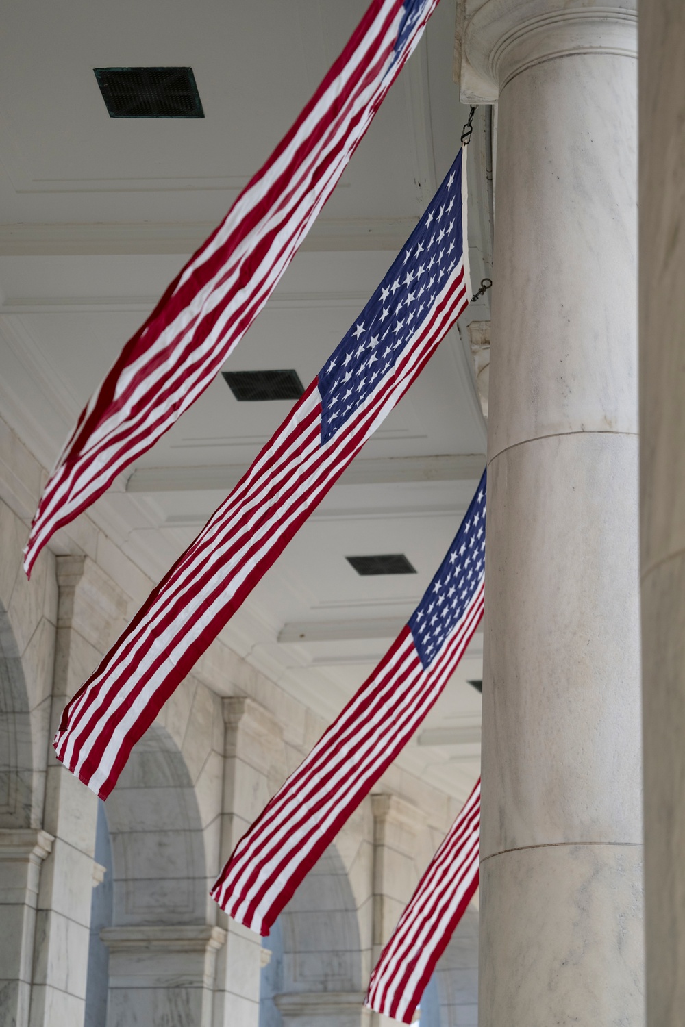 U.S. Flags are Hung in the Memorial Amphitheater in Preparation for the 2024 National Veterans Day Observance