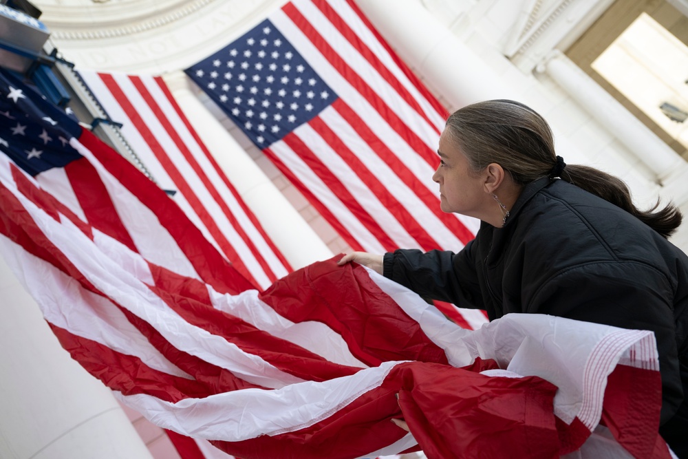 U.S. Flags are Hung in the Memorial Amphitheater in Preparation for the 2024 National Veterans Day Observance