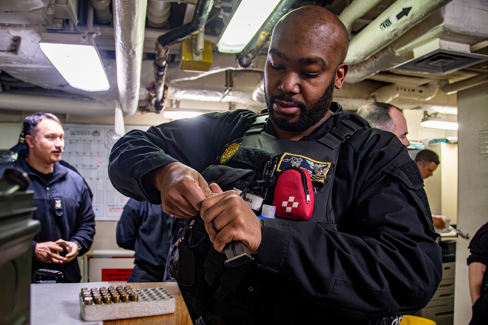 Nimitz Sailor Loads Magazine into an M9 Service Pistol