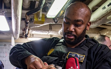 Nimitz Sailor Loads Magazine into an M9 Service Pistol