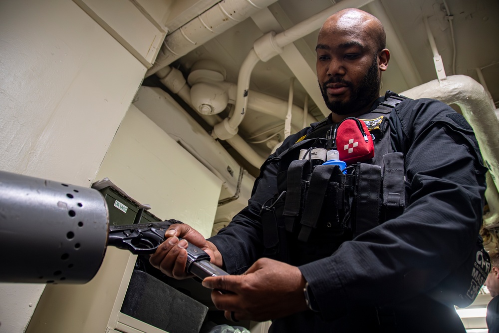 Nimitz Sailor Loads Magazine into an M9 Service Pistol