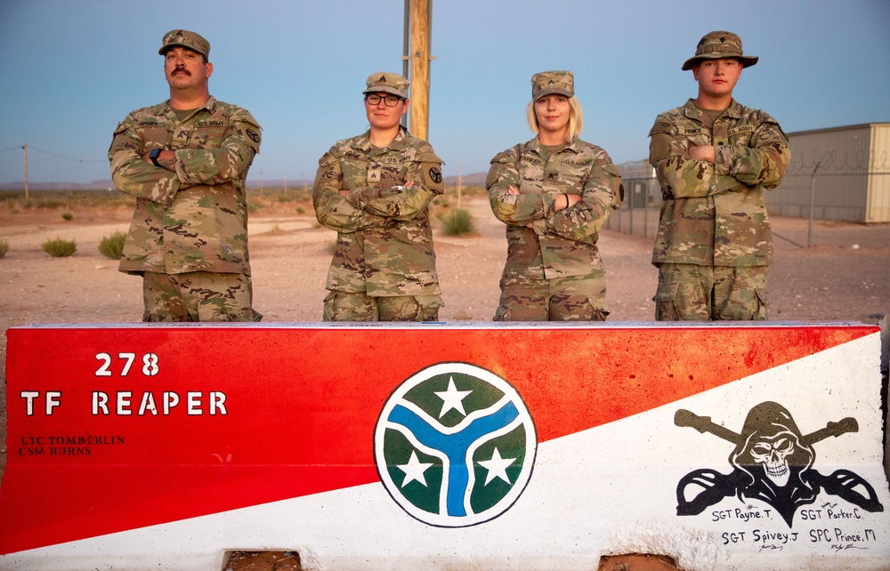 278th Soldiers paint mural on jersey barrier