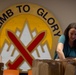 A battalion Soldier Family Readiness Group Leader Stuffs Bags for Soldiers