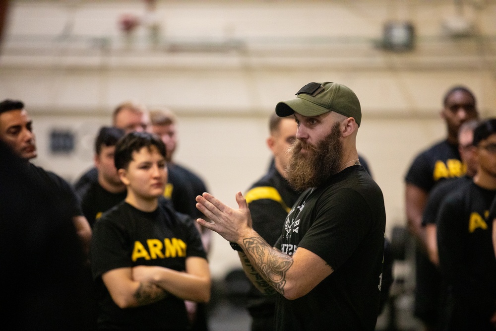 A Holistic Health &amp; Fitness Instructor Addresses Soldiers During Physical Training