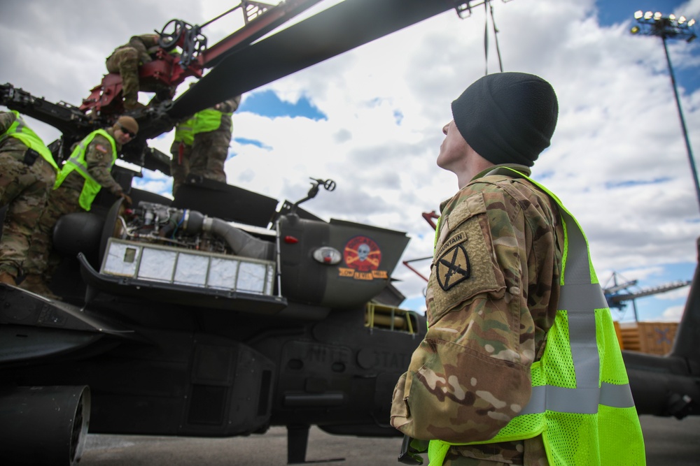 Soldiers Prepare a AH-64D Apache Helicopter for Transport