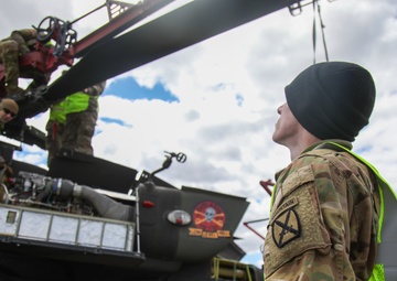 Soldiers Prepare a AH-64D Apache Helicopter for Transport