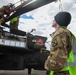 Soldiers Prepare a AH-64D Apache Helicopter for Transport