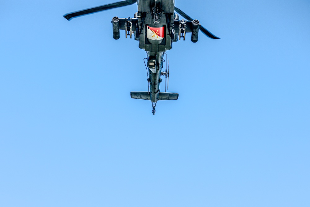 An AH-64D Apache Helicopter Flies Overhead