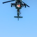 An AH-64D Apache Helicopter Flies Overhead