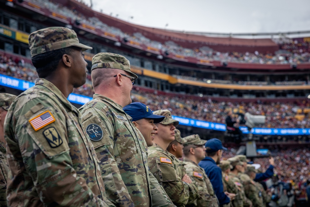 U.S. service members participate in Salute to Service NFL game