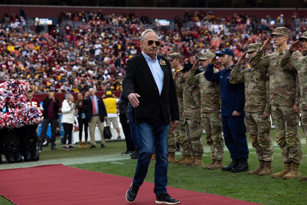 U.S. service members participate in Salute to Service NFL game