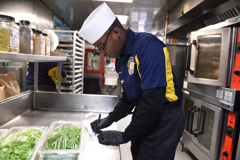 USS John C. Stennis (CVN 74) Sailors prepare meal