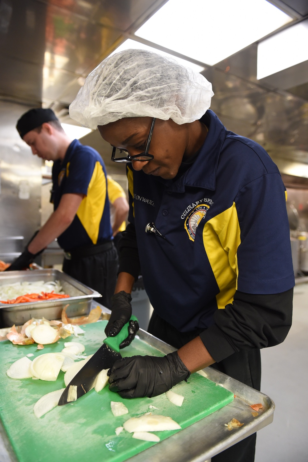 USS John C. Stennis (CVN 74) Sailors prepare meal