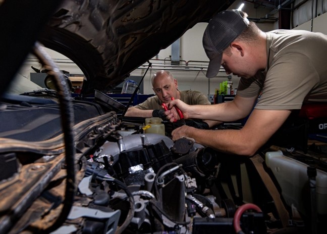 726th EMSS commander pops the hood with vehicle maintenance Airmen