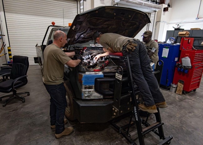 726th EMSS commander pops the hood with vehicle maintenance Airmen