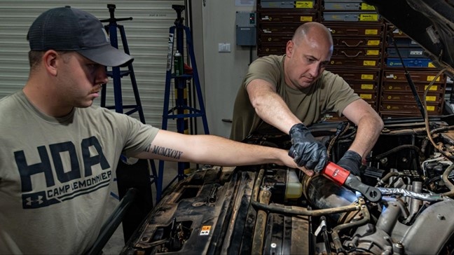 726th EMSS commander pops the hood with vehicle maintenance Airmen