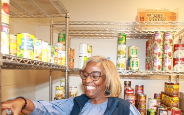 Soldier Family Readiness Specialist Stocks Food Pantry