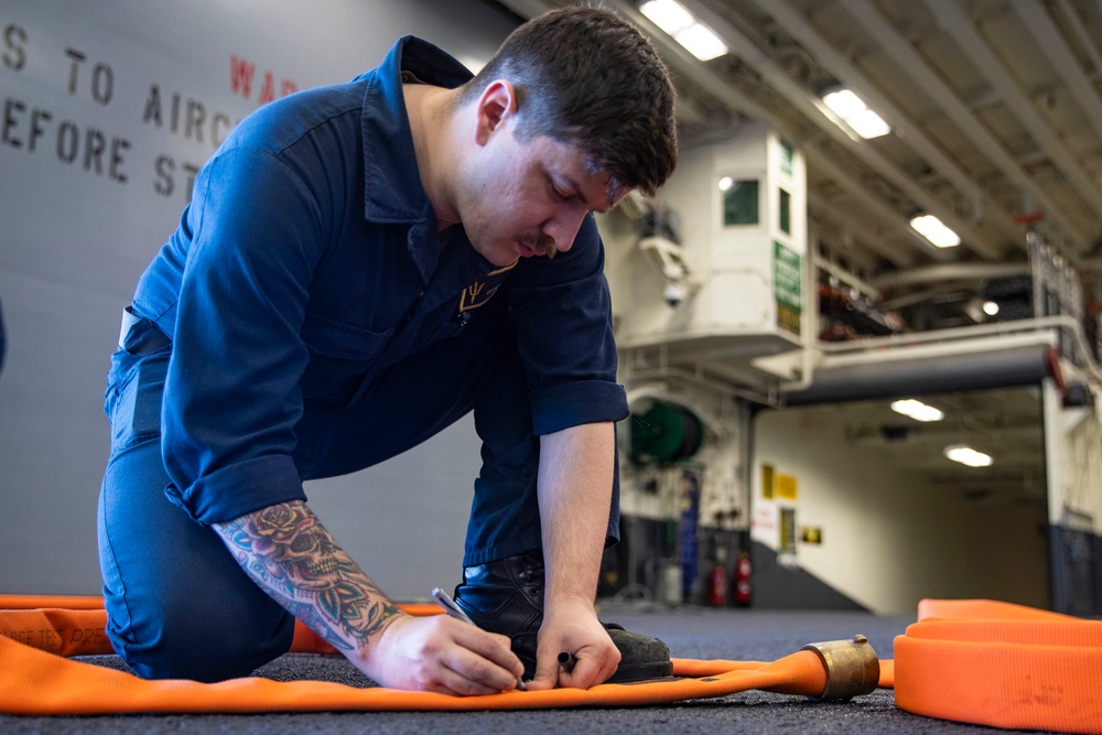 Sailors preform Maintinance onboard USS Tripoli